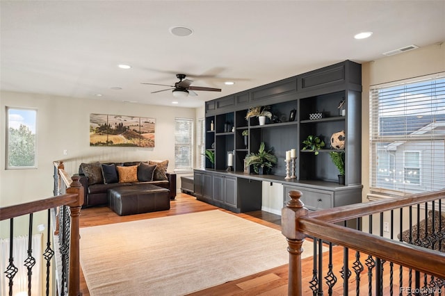 living room with recessed lighting, a ceiling fan, light wood finished floors, and visible vents