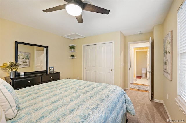 carpeted bedroom featuring baseboards, ceiling fan, a closet, and attic access