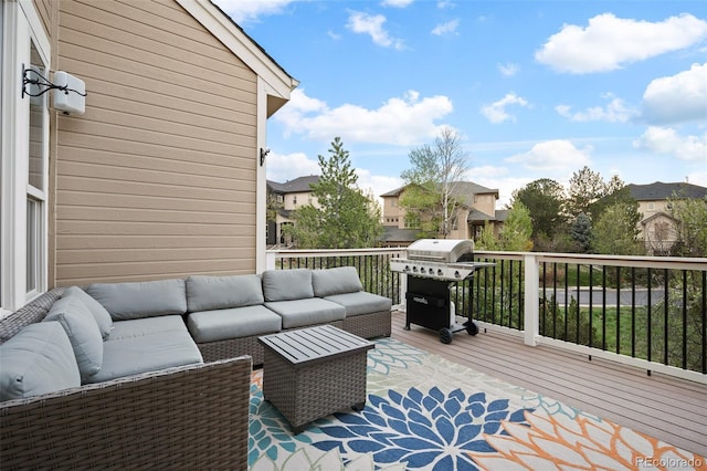 wooden deck featuring outdoor lounge area, a residential view, and a grill
