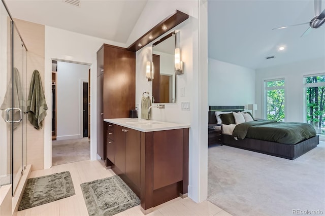 bathroom featuring ceiling fan, a shower with shower door, vanity, and vaulted ceiling