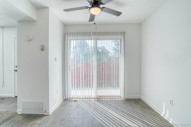 1366 Firefly Cir, Colorado Springs, CO 80916 - unfurnished room featuring wood finished floors, a ceiling fan, a textured ceiling, and baseboards