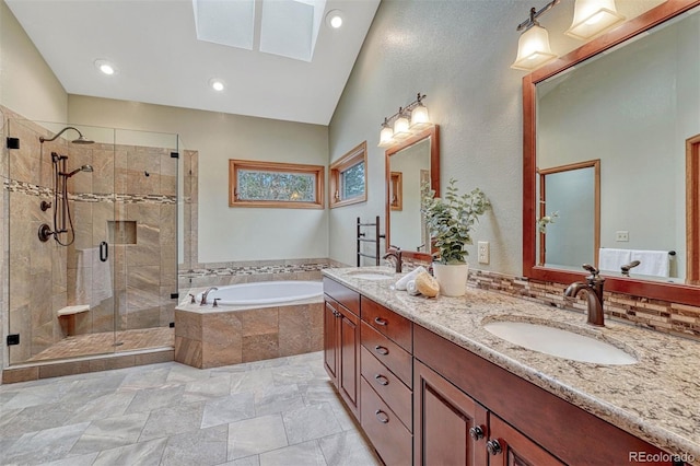 full bathroom with a shower stall, a bath, double vanity, and a sink