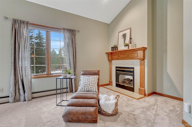 living area with baseboards, carpet, a fireplace, and vaulted ceiling