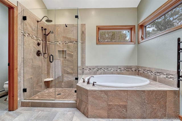 bathroom featuring toilet, a bath, a stall shower, and stone tile flooring