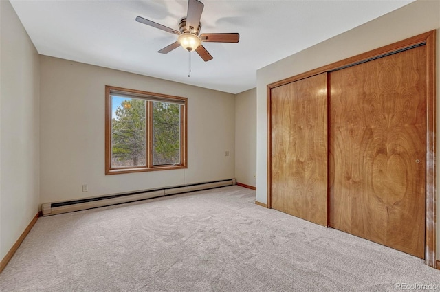 unfurnished bedroom featuring a ceiling fan, a closet, carpet, baseboards, and baseboard heating