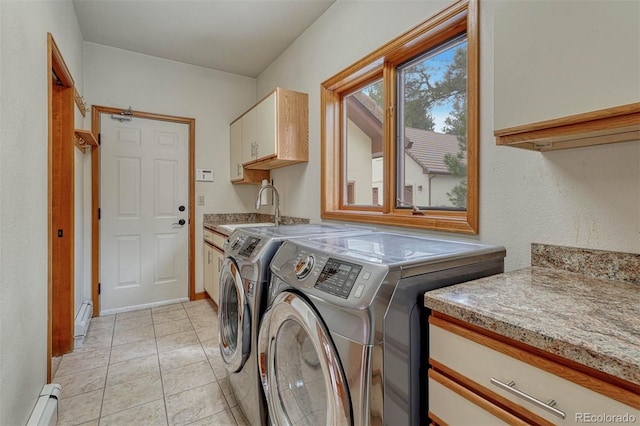 laundry room featuring light tile patterned floors, cabinet space, a sink, a baseboard heating unit, and independent washer and dryer