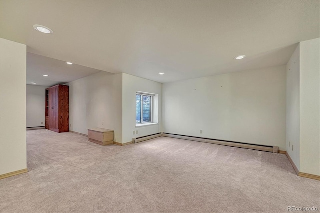 carpeted empty room with recessed lighting, a baseboard heating unit, baseboards, and baseboard heating