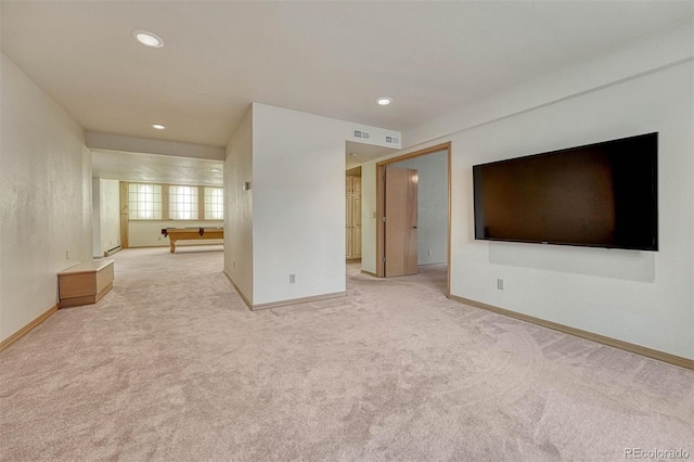 unfurnished living room with light colored carpet and baseboards