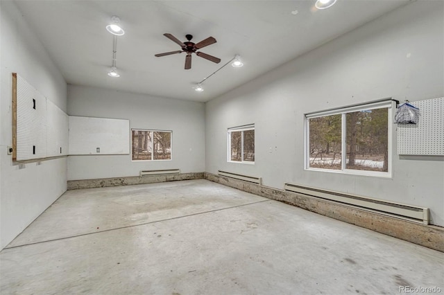 garage featuring a baseboard heating unit and a ceiling fan