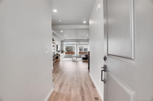 hallway with light hardwood / wood-style floors