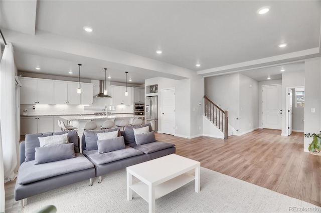 living room featuring sink and light wood-type flooring