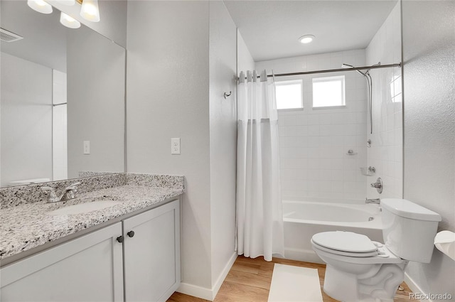 full bathroom with vanity, hardwood / wood-style flooring, toilet, and shower / bathtub combination with curtain