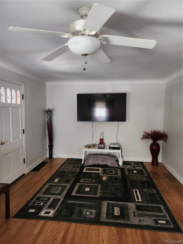 living room with dark hardwood / wood-style flooring and ceiling fan