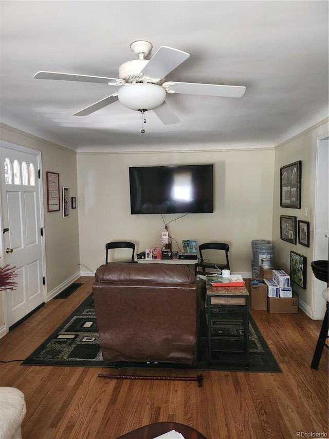 living room featuring dark hardwood / wood-style flooring and ceiling fan