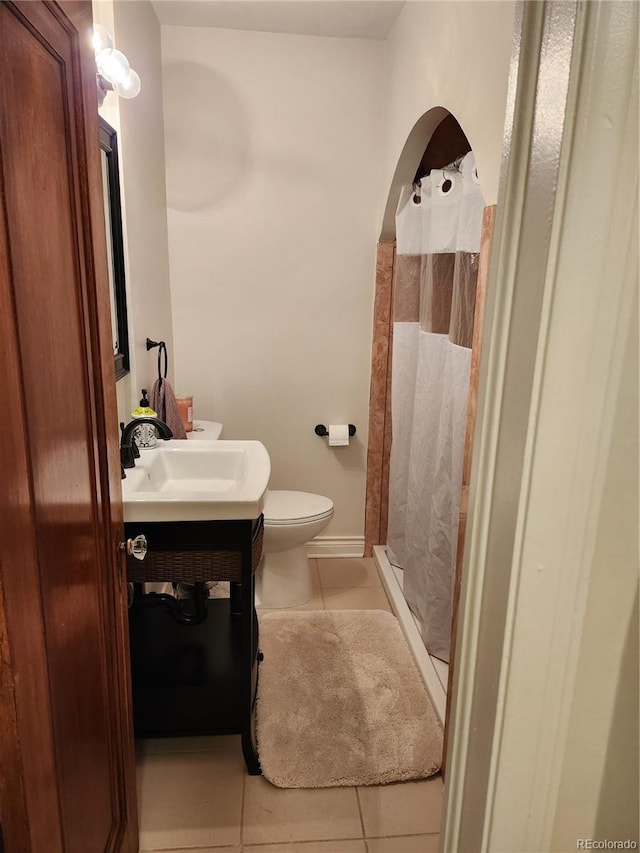 bathroom featuring toilet, vanity, and tile patterned floors