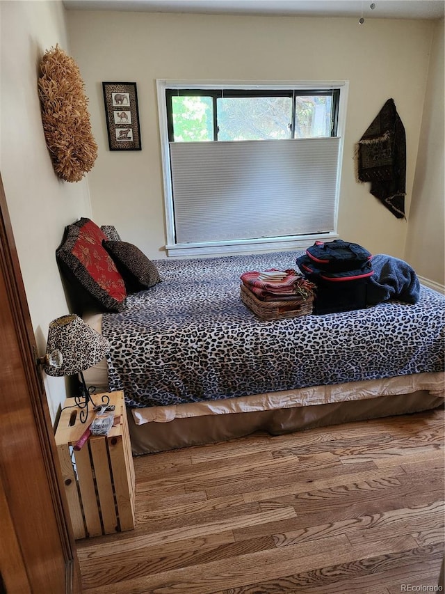 bedroom with hardwood / wood-style floors