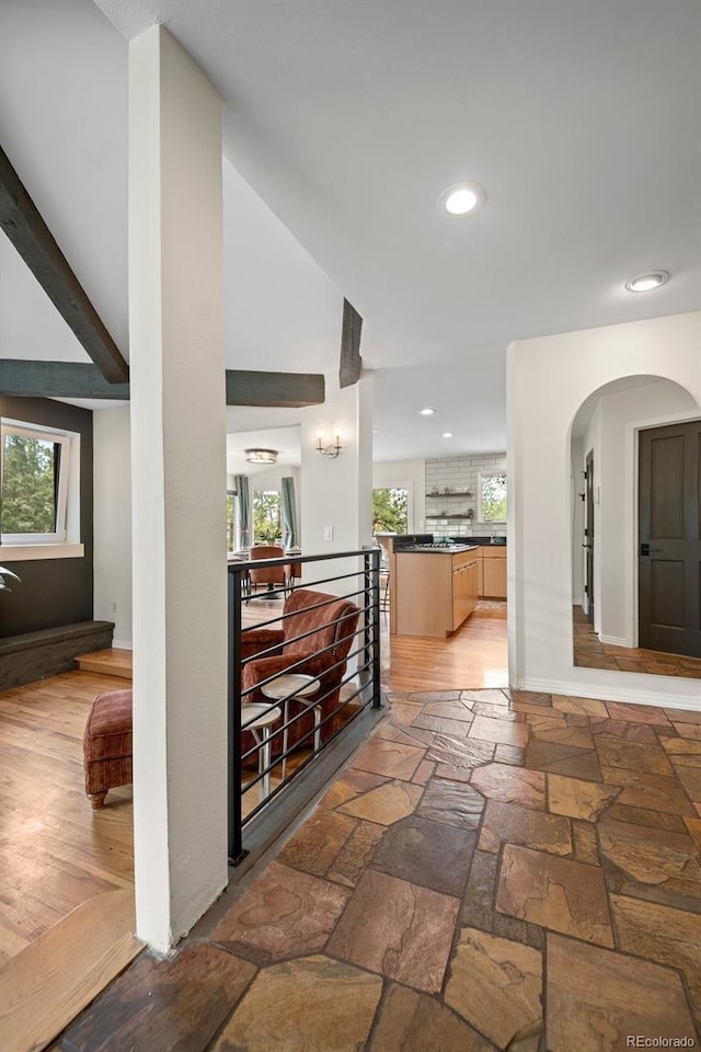 29663 Paint Brush Dr, Evergreen, CO 80439 - hallway featuring arched walkways, recessed lighting, stone tile floors, vaulted ceiling, and baseboards
