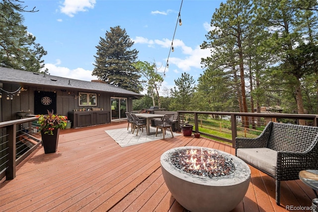 29663 Paint Brush Dr, Evergreen, CO 80439 - deck with outdoor dining space and an outdoor fire pit