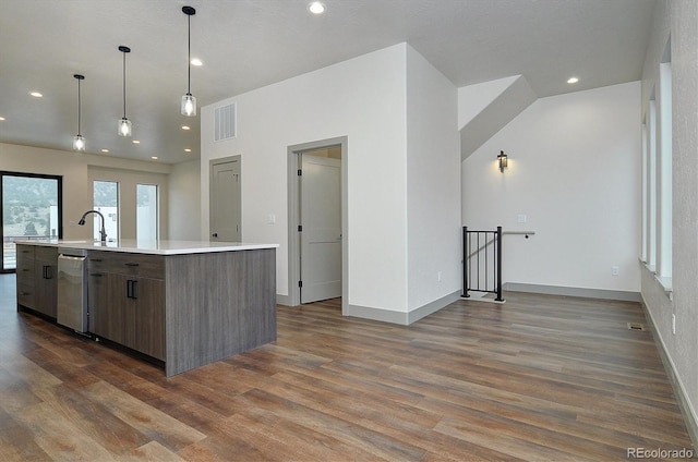 6450 Cleora Rd Unit C, Salida, CO 81201 - kitchen featuring dark wood-type flooring, recessed lighting, light countertops, baseboards, and a center island with sink