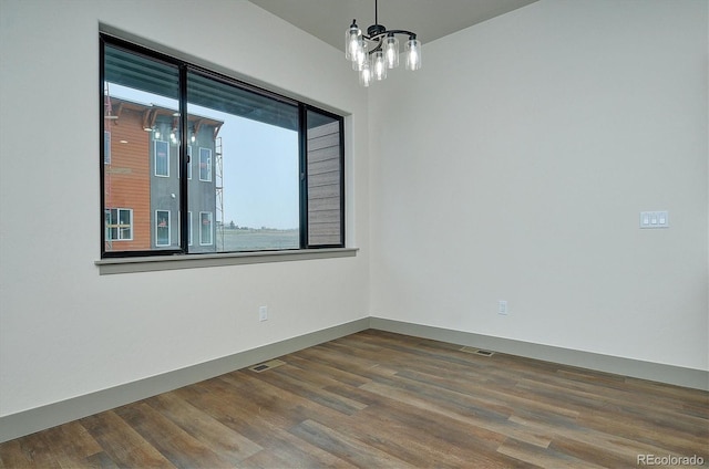 6450 Cleora Rd Unit C, Salida, CO 81201 - spare room with wood finished floors and a chandelier