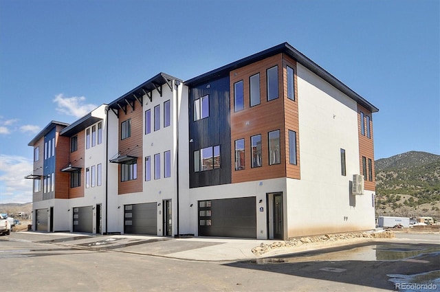 6450 Cleora Rd Unit C, Salida, CO 81201 - view of building exterior featuring an attached garage, a mountain view, and driveway