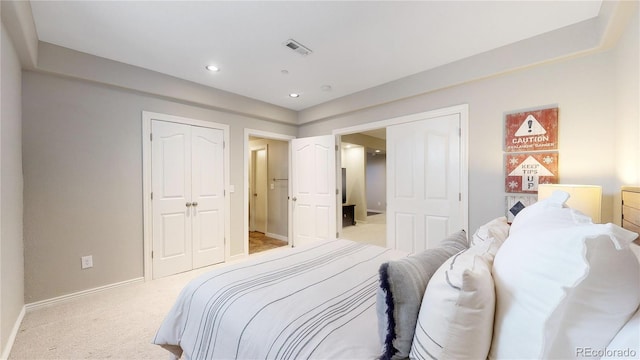 bedroom featuring light colored carpet and a closet