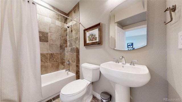 full bathroom with toilet, sink, and shower / bath combo with shower curtain