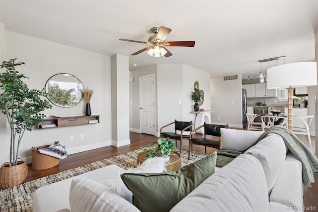 9579 Bighorn Way, Littleton, CO 80125 - living area featuring a ceiling fan and dark wood-style floors
