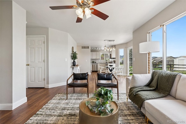9579 Bighorn Way, Littleton, CO 80125 - living area featuring a ceiling fan, dark wood-style floors, and a chandelier