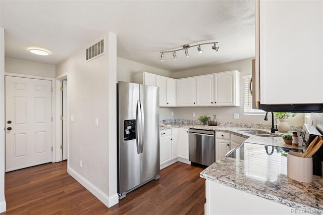 9579 Bighorn Way, Littleton, CO 80125 - kitchen with appliances with stainless steel finishes, dark wood-type flooring, white cabinets, and light stone counters