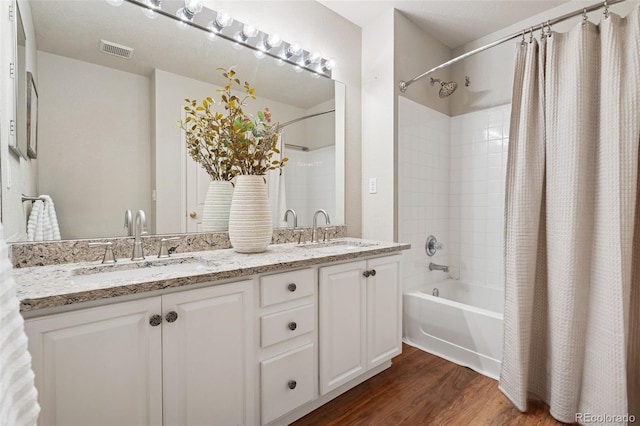 9579 Bighorn Way, Littleton, CO 80125 - full bathroom featuring shower / bathtub combination with curtain, wood finished floors, and double vanity