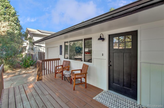 view of exterior entry with a wooden deck