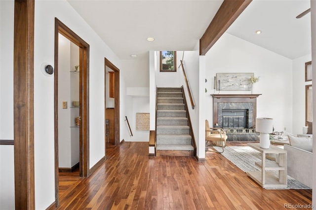 6207 Elbert Pl, Parker, CO 80134 - living area with hardwood / wood-style flooring, stairs, a high end fireplace, and beamed ceiling