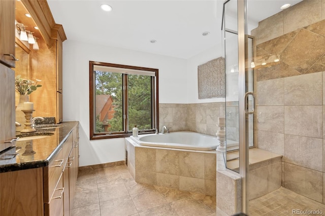 6207 Elbert Pl, Parker, CO 80134 - bathroom featuring double vanity, a garden tub, a stall shower, and recessed lighting