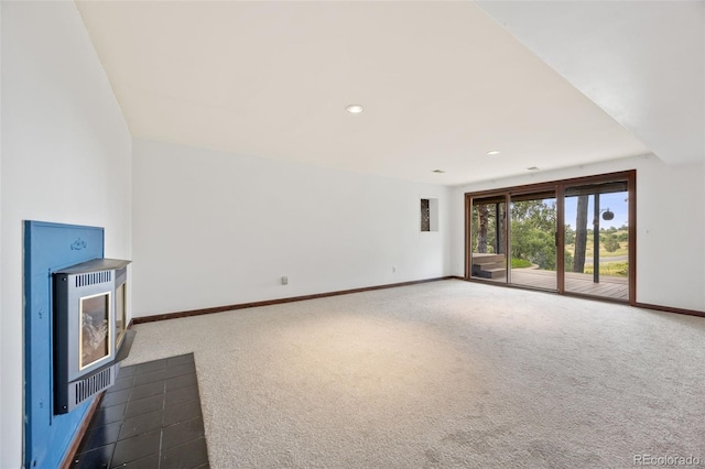 6207 Elbert Pl, Parker, CO 80134 - unfurnished living room featuring carpet flooring, recessed lighting, a wood stove, and heating unit