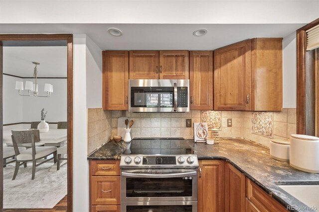 6207 Elbert Pl, Parker, CO 80134 - kitchen featuring appliances with stainless steel finishes, brown cabinets, and recessed lighting