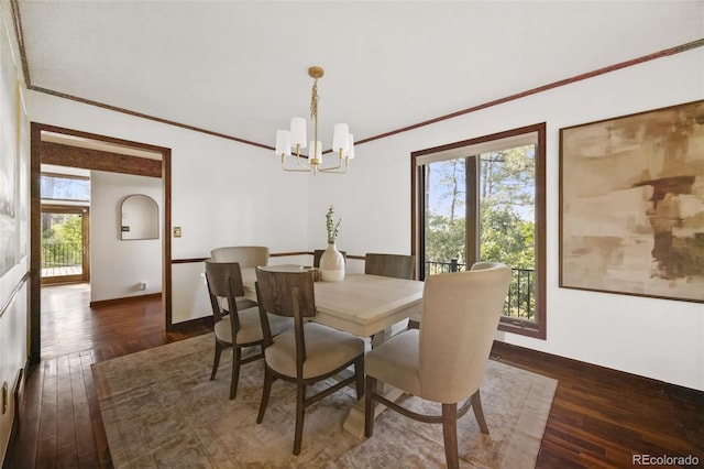 6207 Elbert Pl, Parker, CO 80134 - dining space featuring a chandelier, crown molding, and dark wood-style floors