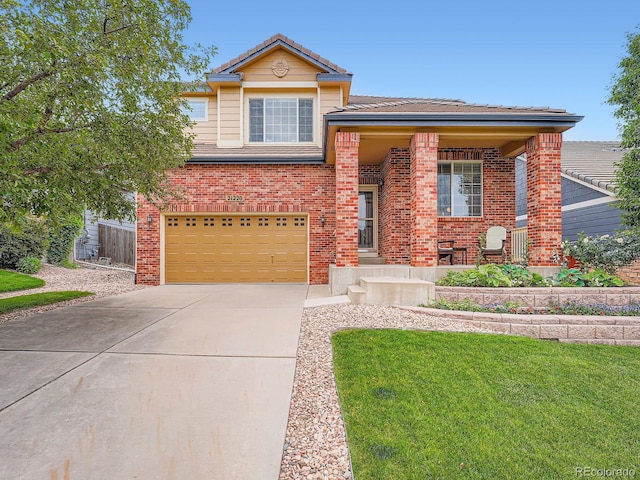 21220 E Nassau Ave, Aurora, CO 80013 - view of front of home featuring brick siding, concrete driveway, a garage, a front yard, and a tile roof