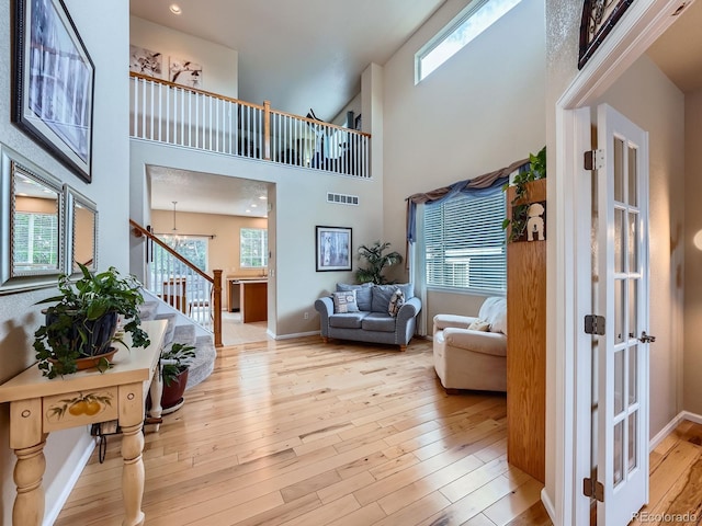 21220 E Nassau Ave, Aurora, CO 80013 - foyer featuring stairs, hardwood / wood-style flooring, healthy amount of natural light, a high ceiling, and a chandelier
