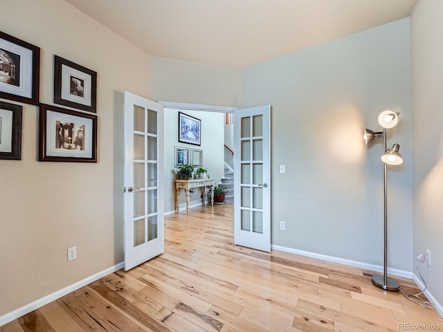 21220 E Nassau Ave, Aurora, CO 80013 - empty room featuring french doors, hardwood / wood-style floors, and stairs
