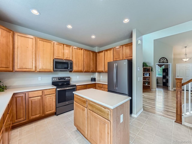 21220 E Nassau Ave, Aurora, CO 80013 - kitchen with stainless steel appliances, light countertops, recessed lighting, light tile patterned flooring, and a center island