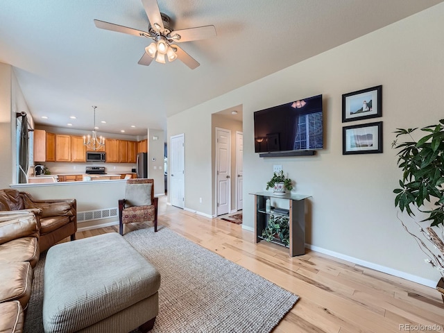 21220 E Nassau Ave, Aurora, CO 80013 - living area featuring a chandelier, ceiling fan, light wood-type flooring, and recessed lighting