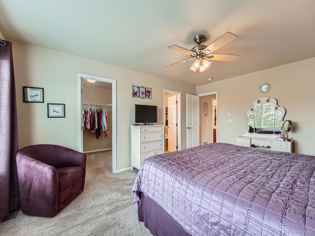 21220 E Nassau Ave, Aurora, CO 80013 - bedroom with light carpet, a walk in closet, ceiling fan, a closet, and ensuite bathroom