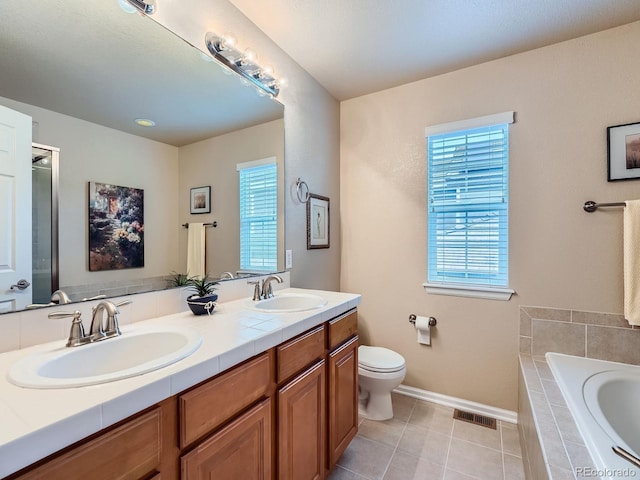 21220 E Nassau Ave, Aurora, CO 80013 - bathroom featuring plenty of natural light, a bath, double vanity, and tile patterned flooring