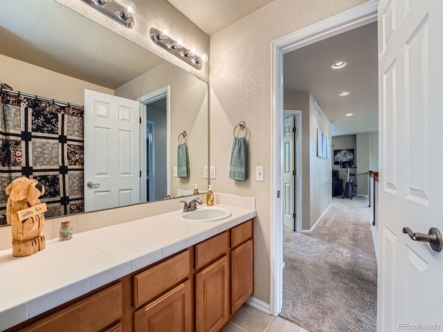 21220 E Nassau Ave, Aurora, CO 80013 - full bath with vanity, a textured wall, and recessed lighting