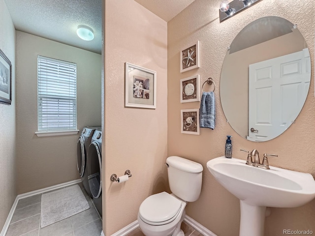 21220 E Nassau Ave, Aurora, CO 80013 - bathroom with washing machine and dryer and tile patterned flooring