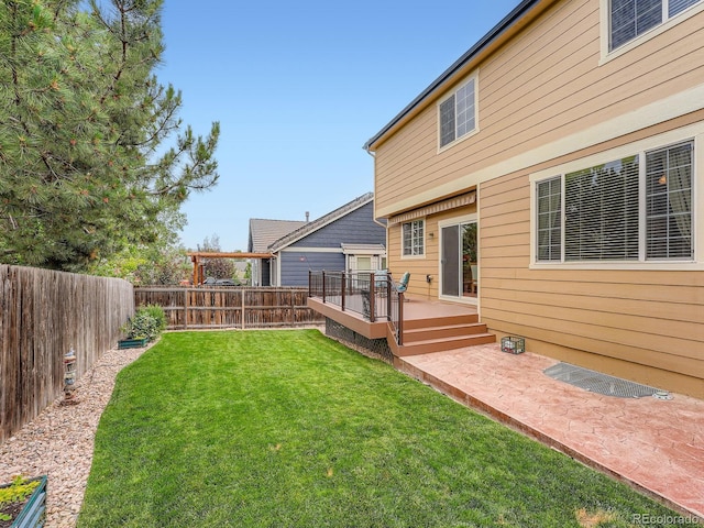21220 E Nassau Ave, Aurora, CO 80013 - fenced backyard featuring a deck and a patio