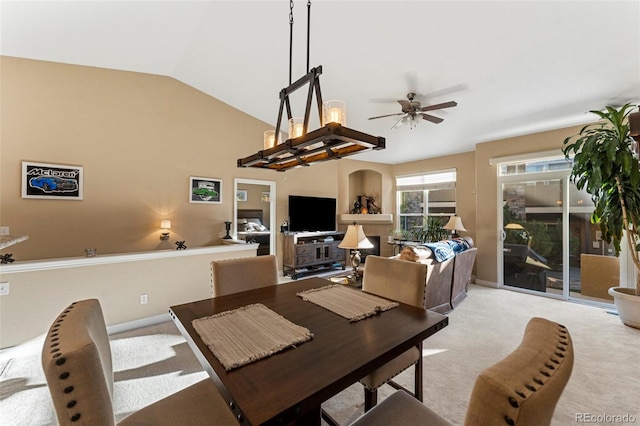 dining space featuring lofted ceiling, ceiling fan, and light colored carpet