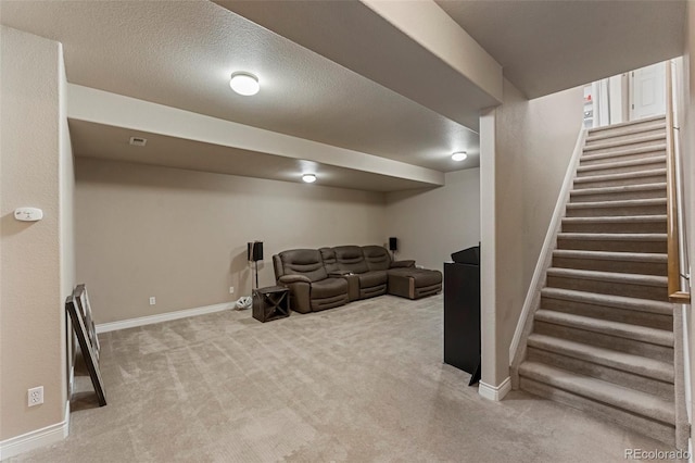 living room with a textured ceiling and light carpet