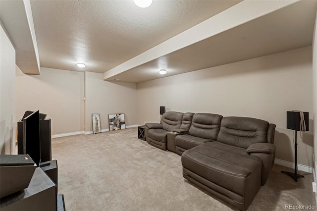 carpeted home theater room with a textured ceiling